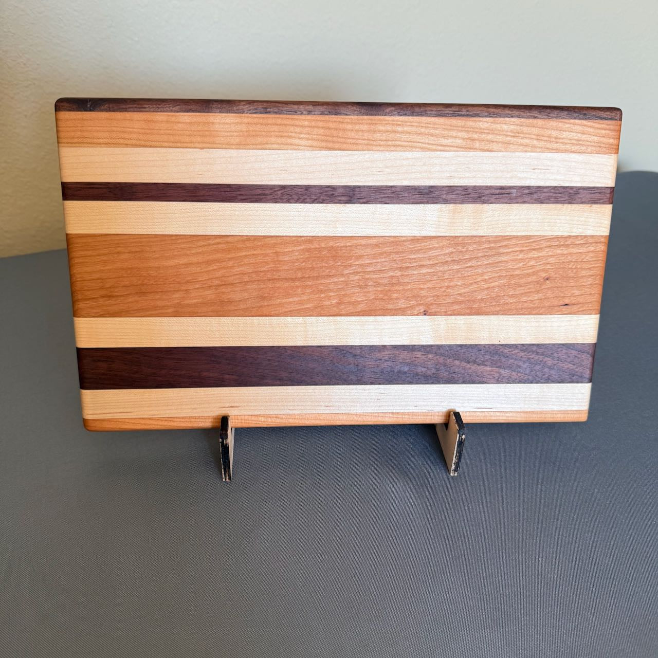 Solid hardwood chopping with random stripes of varied colored hardwood seen standing on edge. Measures 8 x 13.