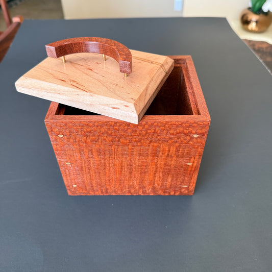 Beautifully crafted keepsake box with the lid sitting off to one sdie of the top.. The body is make of leopard wood with an ambrosia maple top. The handle is a crescent moon shape standing on three thin brass posts. For additional help please reach out to me.